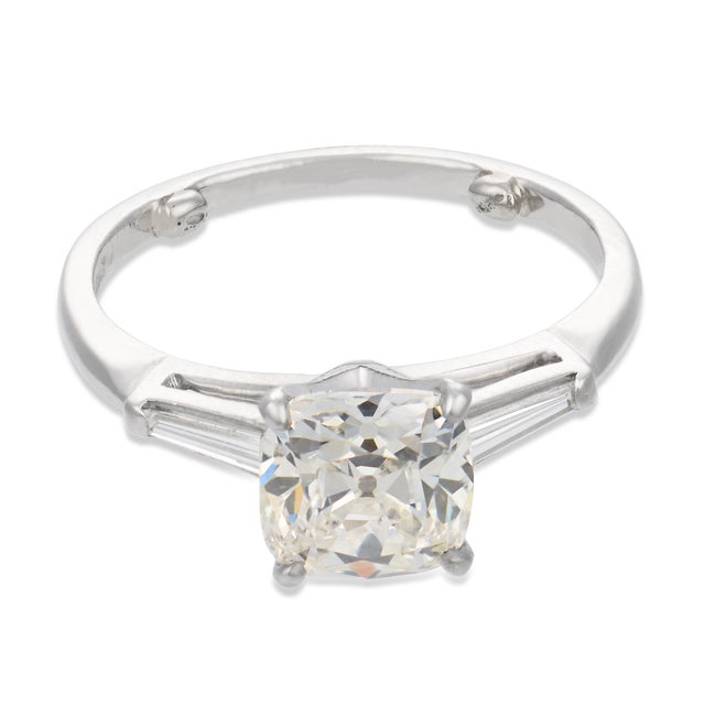 This elegant Art Deco engagement ring centers on a captivating 1.62 carat old mine cut diamond, certified by GIA...