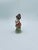 A vintage-style collectible figurine, crafted from high-quality bisque porcelain. The figurine depicts a seated girl...