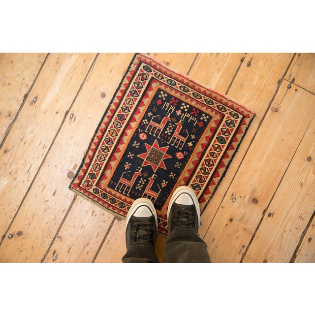 :: Unidirectional pictorial design motif with checkered blossoms and inwardly facing four legged animals in the main field...