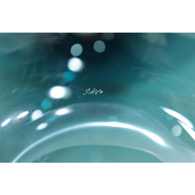 Organic spheres of handblown Czech glass with broken flame polished mouths. They are entirely free‑blown, produced without...