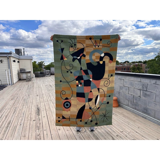 Monumental late 20th century wool wall tapestry in the style of Joan Miro. Wool is stitched onto a canvas background....