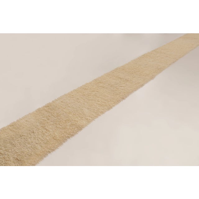 Made with hand-knotted wool and originating circa 1950-1960, this 3x26 vintage Turkish Tulu runner rug features a thick,...