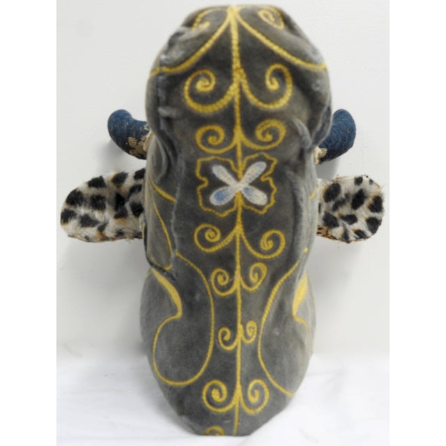 An exquisite porcelain wall mount heifer that sports a variety of vintage and antique textiles. The main part of her face...