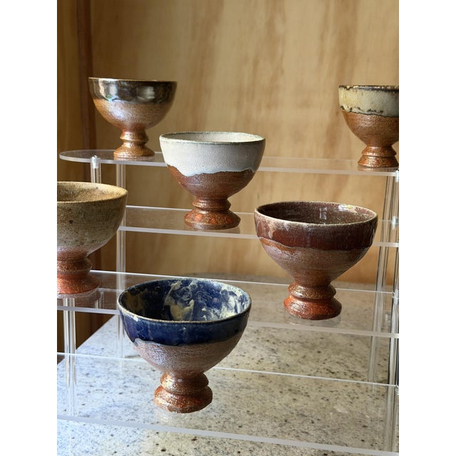 The Essence of the Vessel This curated collection of six footed bowls celebrates the tactile beauty of contemporary studio...