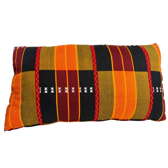 The African Kente cotton Cloth Pillow is a unique and stylish addition to any home decor, featuring a lumbar shape with...