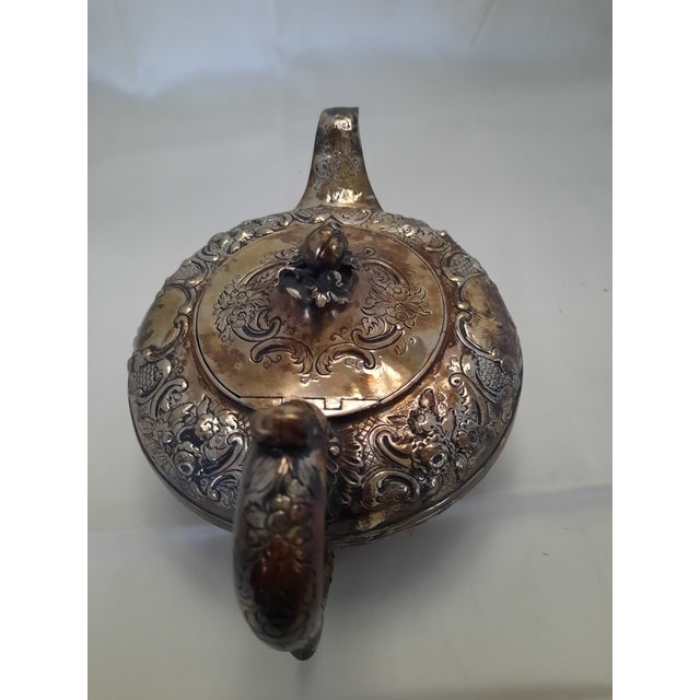 An exceptional English sterling silver teapot of richly ornamented late-Victorian/Edwardian character, assayed in...