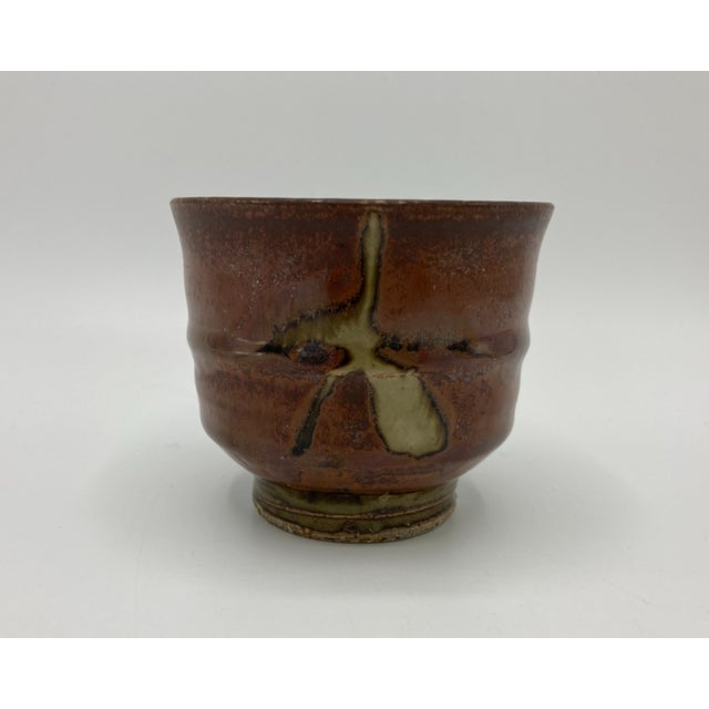This is a vintage studio pottery yunomi or Japanese teacup by Eric Norstad (Bay Area California). The teacup is...