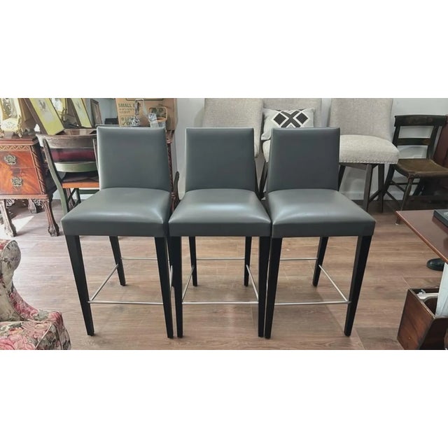 Sleek, modern, and built for comfort, this set of three high-back counter stools brings clean contemporary style to any...