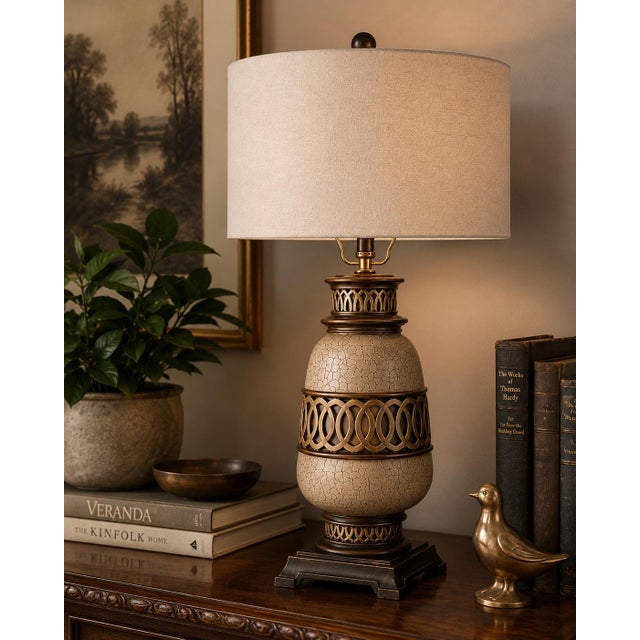 A sculptural architectural urn table lamp featuring a crackle-finished body, decorative open fretwork detailing, rich...