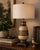 A sculptural architectural urn table lamp featuring a crackle-finished body, decorative open fretwork detailing, rich...