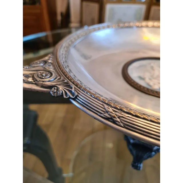 Antique-style tazza signed WMF, late 19th century, in silver-plated metal with central motif in biscuit porcelain. This...