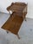 This is a mid-century wooden end table/side table featuring a tiered top, base shelf and turned legs. sturdy and in good...
