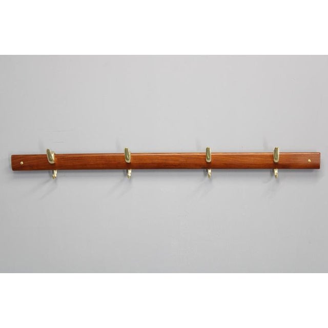 Rare and iconic coat hanger designed by Carl Auböck for Illums Bolighus in Denmark during the 1950s, blending elegant...