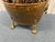 This antique copper and brass kindling holder is a striking hearth accessory featuring ornate lion‑head ring pulls,...