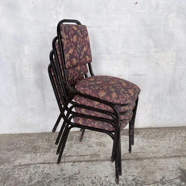 a characterful set of four mid-century stacking dining chairs with slender tubular metal frames and colourful seats. Their...