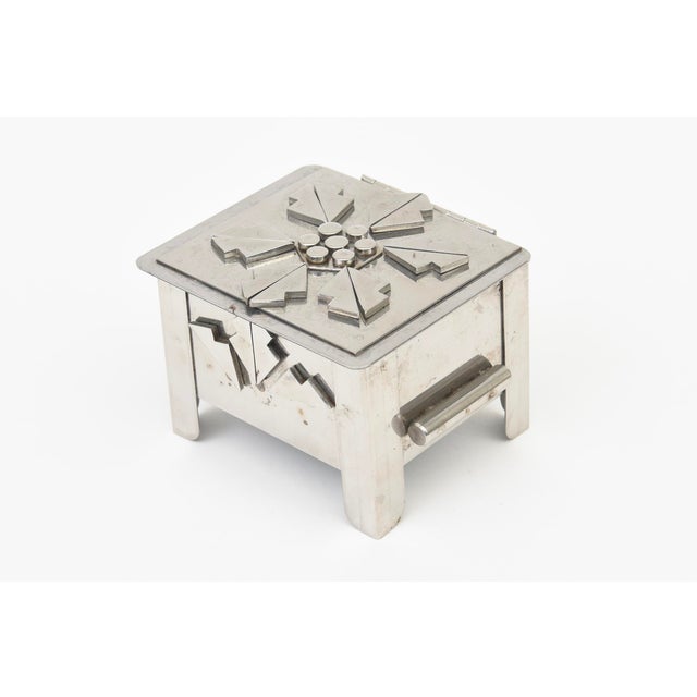 This very special small stainless steel hinged box is modernist in design and from the 80's.All hand crafted. It is by the...