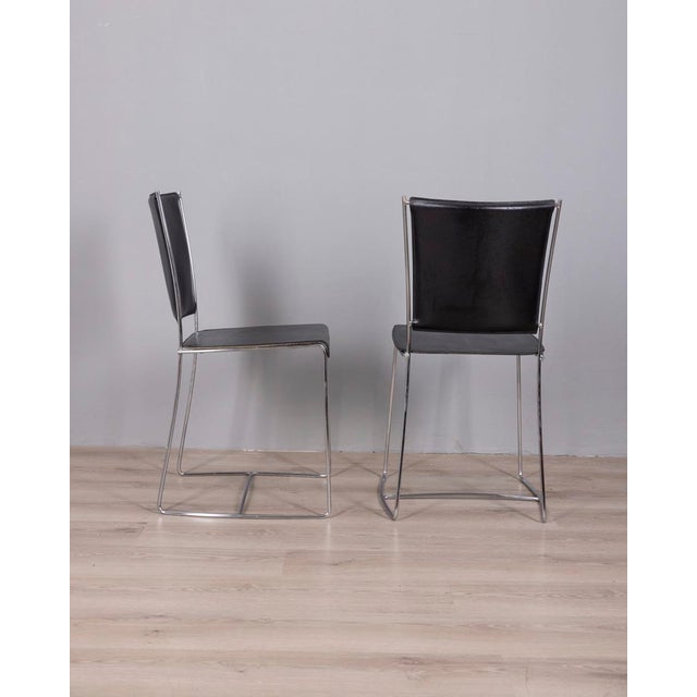 Pair of chairs with chromed metal frame and black leather seat, Italian design, 1990s. I have official proof of...