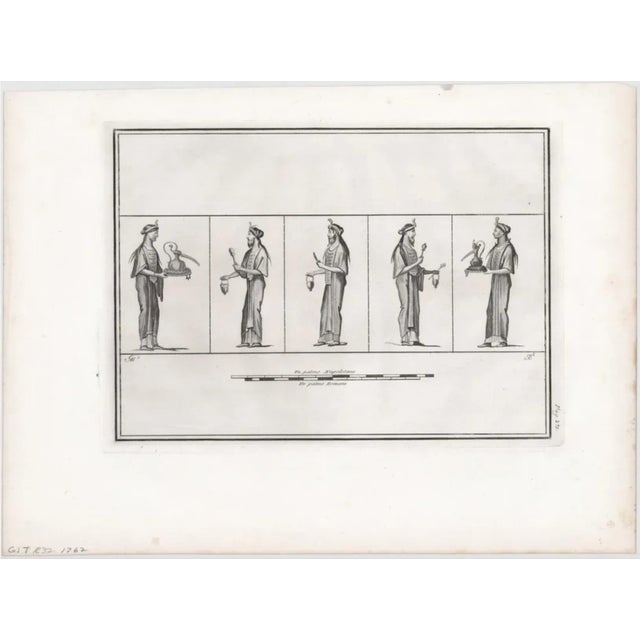 1762 engraving of a classical figure, possibly a servant or priest, holding items for a ritual or ceremony.