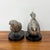 A charming pair of solid metal bird sculptures, each rendered with highly detailed feathering and expressive naturalistic...