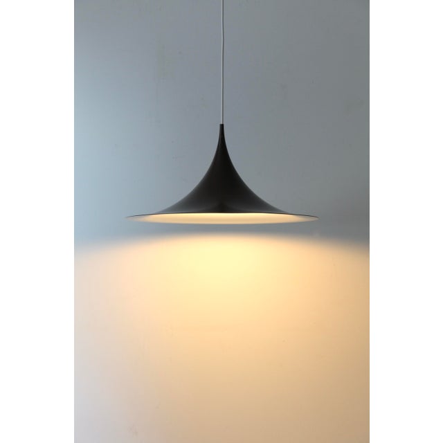 Iconic 'semi' pendant lamp in the beautiful chocolate brown color – captivating with its unique, delicate aesthetic! this...