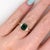 An emerald glows in a rich green at the centre of this solid 14K yellow gold ring, encircled by ten earth-mined diamonds....