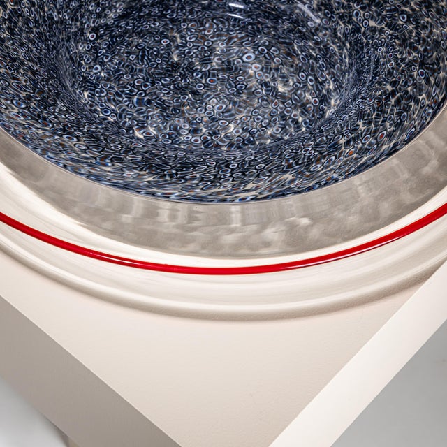Large centerpiece in gray-blue murrine glass with a clear rim and red edge. Designed by Gae Aulenti for Vistosi. Signed...