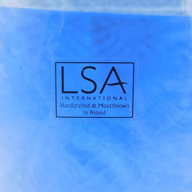 This is a slender blue art glass vase by LSA of Poland. The vase is marked Handcrafted and Handblown in Poland. I am not...