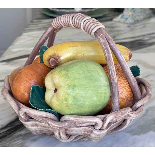 Life-like and in very good vintage condition, here is a ceramic majolica style basket of fruit made in Italy. Hand painted...