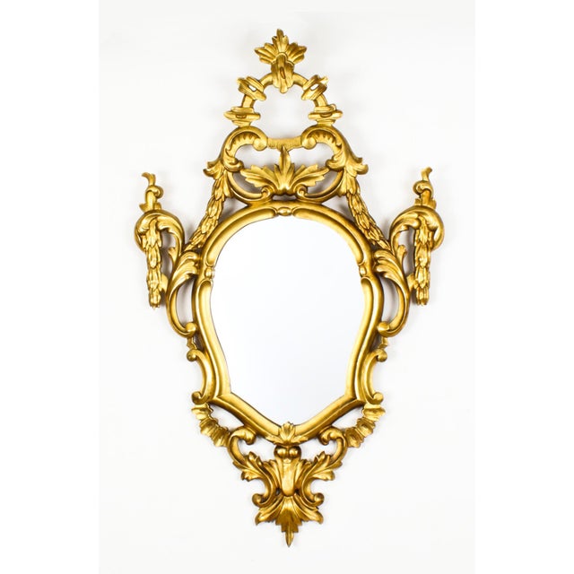 This is a superb pair of antique Italian Florentine giltwood mirrors, circa 1870 in date. The oval mirrors plates are set...