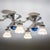 Set of four large ceiling lights in chrome-plated metal, each fitted with two chalice-shaped glass shades with wavy rims....