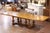 Crafted in France circa 1920, this elegant mid-century extendable dining table showcases a striking parquetry top and...