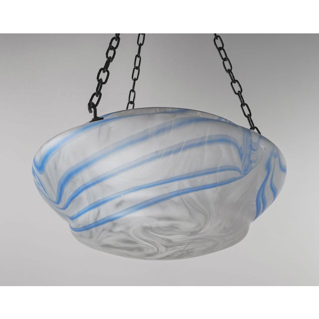A near-antique plafonnier (or flycatcher) shade made of clear glass with opal white streaks overlapped by blue stripes,...