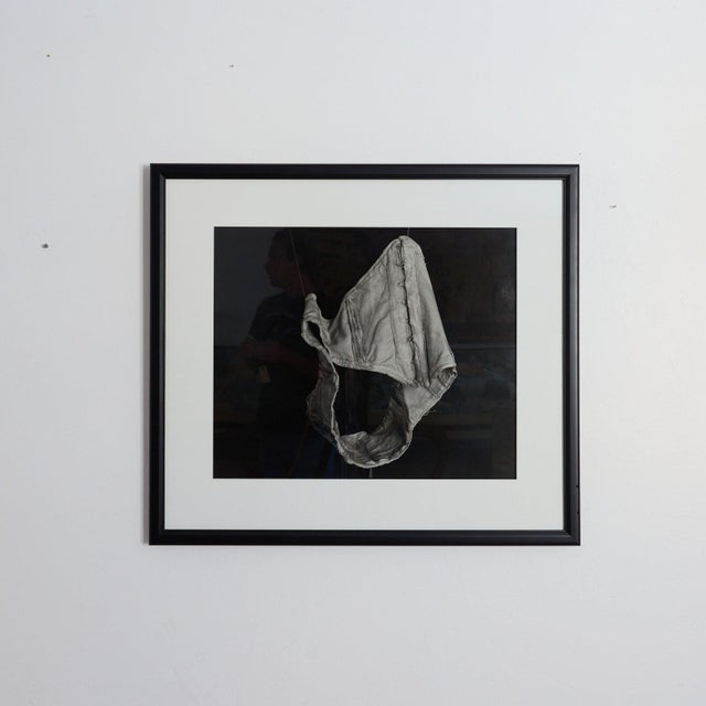 Monochrome vintage corset study in black and white tones, presented in a black wood frame with a wide white mat.