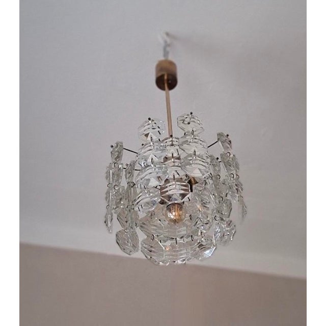 Kinkeldey chandelier in brass from the 1960s with 3 levels of faceted glass crystals cut in octagonal shapes hanging from...