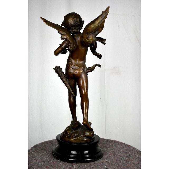 A superb bronze with brown patina "cupid" by louis auguste moreau style with a very nice patina, black marble base, it is...