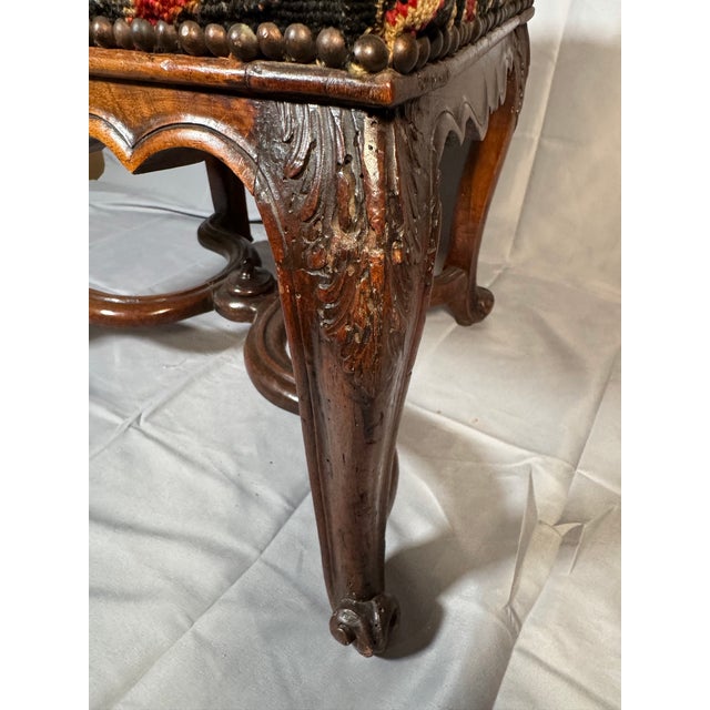 • Material: Carved walnut, hand-woven jute webbing, original petit-point needlepoint seat • Color/Finish: Deep warm walnut...