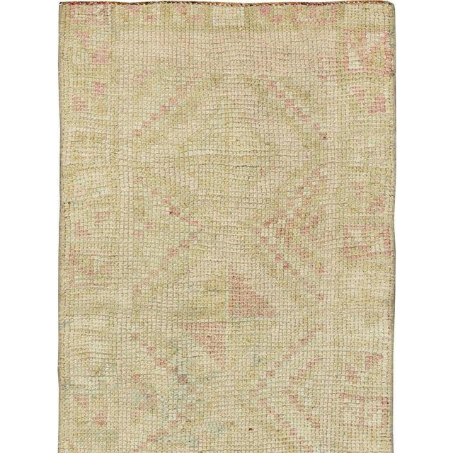 This mid-20th-century Turkish Anatolian runner presents a quiet geometric composition in a softly restrained palette of...
