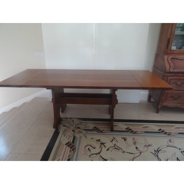 A one and a half inch thick tongue and groove tabletop. along with keyed tenons and. a trestle base make this table....