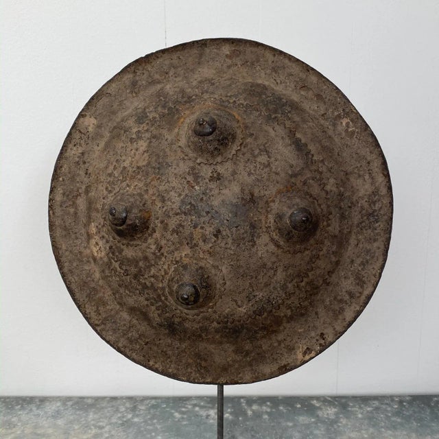 A small Ottoman fighting shield, 17th Century on later custom steel stand.