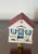 Cute Beach Cottage with red roof miniature on brass base as lamp finial. 2,5” by 2,5”.