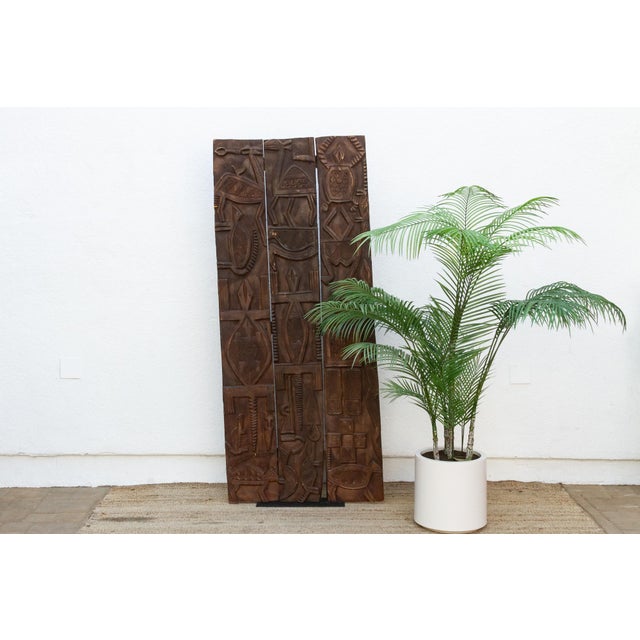 From the Nupe people of central Nigeria's Niger River region, this striking door is built from three narrow vertical...