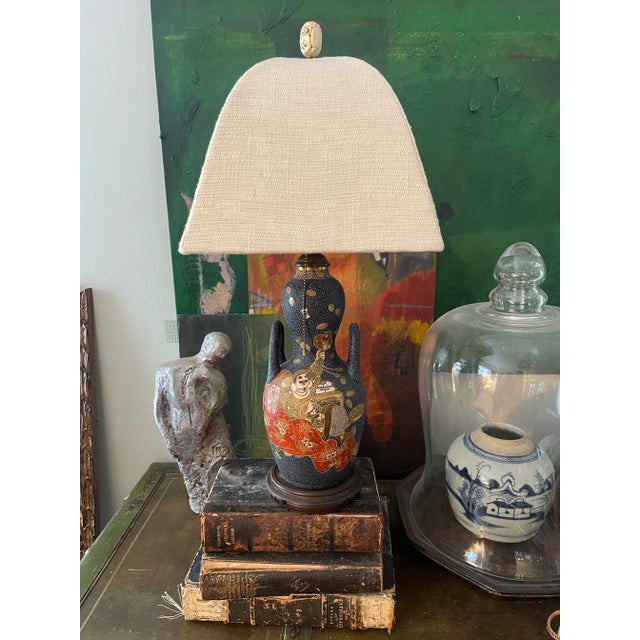 Wonderful old Satsuma lamp, presented in a deep, blue textured surface, depicting, two individuals and traditional...