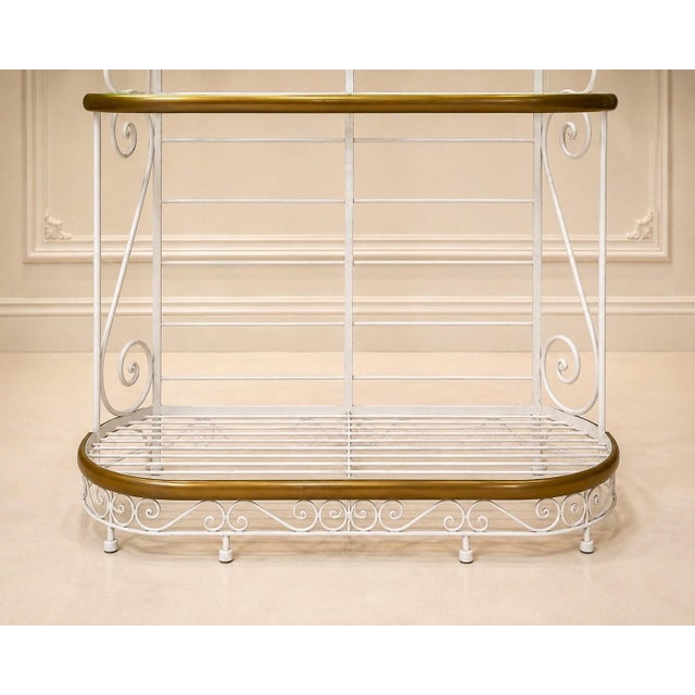 A white lacquered iron baker's shelf with three shelves featuring oval and semi-oval profiles, circa 1900. Each shelf has...
