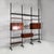 Italian mid-century modern modular bookcase in wood and metal, 1960s Modular ceiling-floor bookcase in wood. It features...
