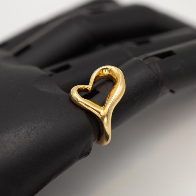 Preowned Tiffany & Co. Elsa Peretti Open Heart Ring crafted in 18k yellow gold Ring Size: 5.75 Approximate Weight: Gross -...
