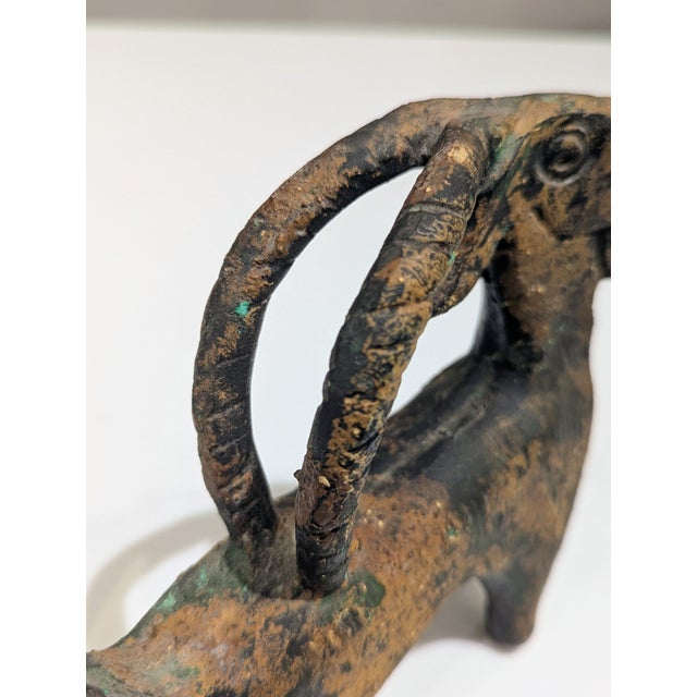 Ibex sculpture cast in heavy bronze with deep oxidation and verdigris patina. The form is inspired by ancient Near Eastern...