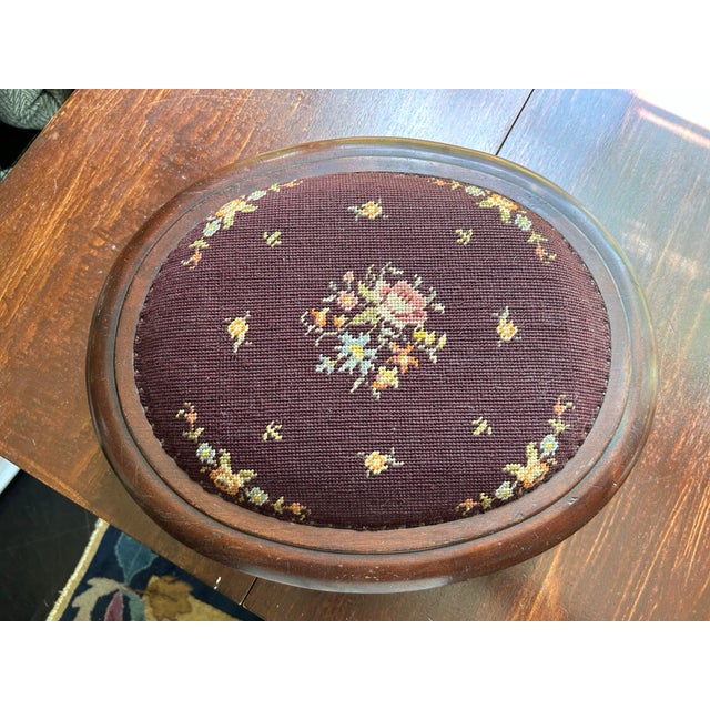 A small hand stitched needlepoint stool