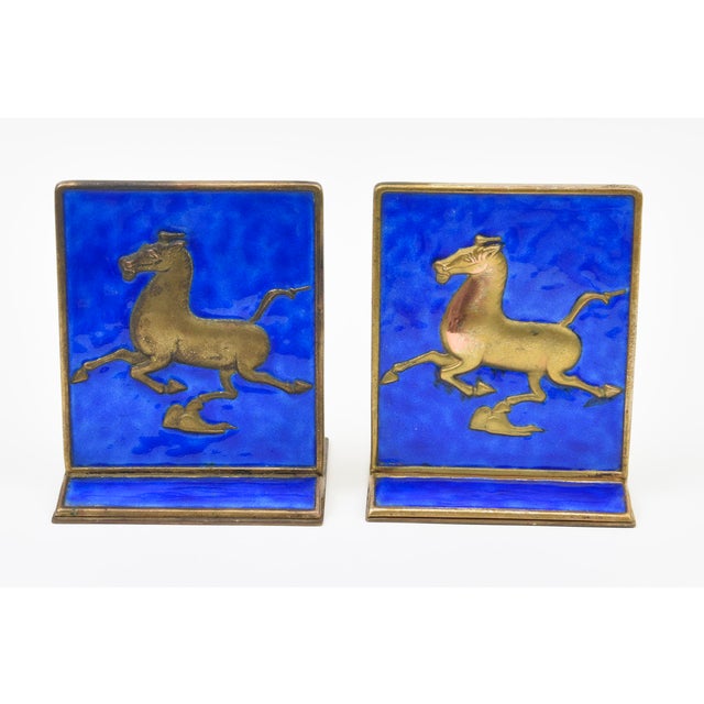 These Interesting looking vintage Chinese gold plated over copper bookends enamel of horses in a rich color of royal blue....