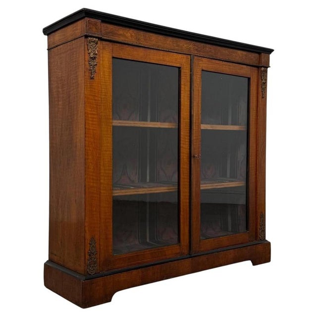 A handsome and finely crafted 19th-century English Victorian pier cabinet, beautifully constructed in walnut and...