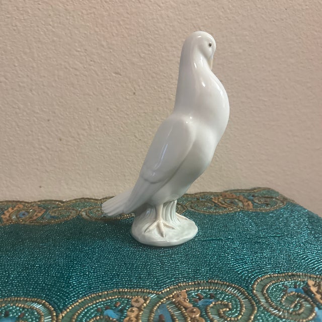Add a touch of classic elegance to your home with this beautiful white porcelain pigeon figurine. Featuring a sleek,...
